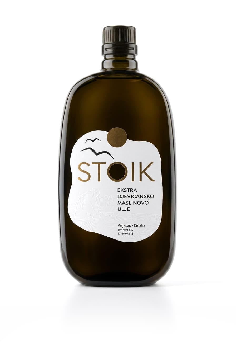 A 500 ml bottle of STOIK extra virgin olive oil with its white label, gold sun and seagulls